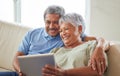 Senior couple, tablet and communication on social media or video call with elderly husband and wife relaxing on the Royalty Free Stock Photo