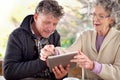 Senior couple, tablet or communication to relax on social media, website or bonding together. Older married people Royalty Free Stock Photo