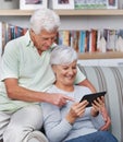 Senior couple, tablet and home on couch for social media, online news app and reading ebook. Happy old man, elderly Royalty Free Stock Photo