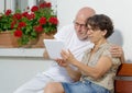 Senior couple with a tablet, outdoor Royalty Free Stock Photo