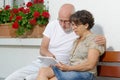 Senior couple with a tablet, outside Royalty Free Stock Photo