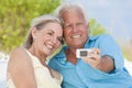 Senior Couple Taking Photographs On Cell Phone