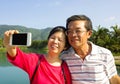 Senior couple taking picture by themselves in outside Royalty Free Stock Photo