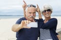 Senior couple taking selfie on beach Royalty Free Stock Photo