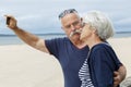 senior couple taking selfie at beach Royalty Free Stock Photo