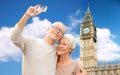 Senior couple taking selfie on camera over big ben Royalty Free Stock Photo