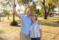 Senior couple taking selfie having fun in the park. back to life after coronavirus lockdown concept Royalty Free Stock Photo