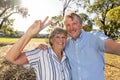 Senior couple taking selfie having fun in the park. back to life after coronavirus lockdown concept Royalty Free Stock Photo