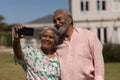 Senior couple taking selfie with mobile phone in the backyard Royalty Free Stock Photo