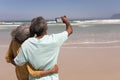 Senior couple taking selfie with mobile phone on beach Royalty Free Stock Photo