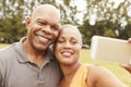 Senior Couple Taking Selfie In Park Royalty Free Stock Photo