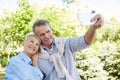 Senior Couple Taking Selfie in Park Royalty Free Stock Photo