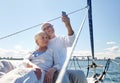 Senior couple taking selfie by smartphone on yacht Royalty Free Stock Photo
