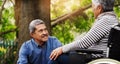 Senior couple, talk and wheelchair in park by trees with love, connection and smile on vacation in summer. Elderly woman Royalty Free Stock Photo