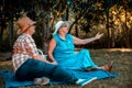 Happy senior couple having picnic and talking on the beach Royalty Free Stock Photo