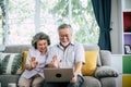 Senior couple talking with laptop computer