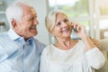 Senior couple talking on mobile phone at home Royalty Free Stock Photo