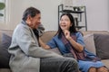 A senior couple in their 60s spends their free time relaxing and having fun together on the sofa in the living room. Royalty Free Stock Photo