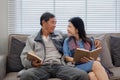 A senior couple in their 60s spends their free time sitting and reading book, relaxing and having fun together on the Royalty Free Stock Photo