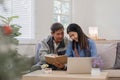 A senior couple in their 60s spends their free time sitting and reading book, relaxing and having fun together on the Royalty Free Stock Photo