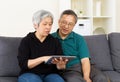 Senior couple with touchpad sitting Royalty Free Stock Photo