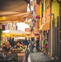 Senior couple tourists in italian restaurant, caucasian old man and asiatic lady dining in picturesque traditional