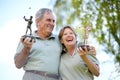 Senior couple, trophy or golfers with success for winning a sports tournament on golf course together. Excited, golfing Royalty Free Stock Photo