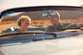 Senior couple on a US road trip, seen through car windscreen Royalty Free Stock Photo