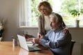 Senior couple using app at home, studying new online app Royalty Free Stock Photo