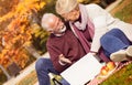 Senior couple using lap top outdoor Royalty Free Stock Photo