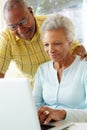 Senior Couple Using Laptop At Home Royalty Free Stock Photo