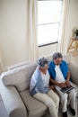 Senior couple using laptop in living room Royalty Free Stock Photo