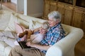 Senior couple using laptop in living room Royalty Free Stock Photo