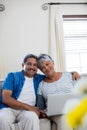 Senior couple using laptop in living room at home Royalty Free Stock Photo