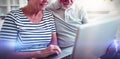 Senior couple using laptop in living room Royalty Free Stock Photo