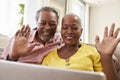 Senior Couple Using Laptop To Connect With Family For Video Call