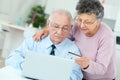 Senior couple using notebook at home Royalty Free Stock Photo