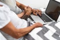 Senior couple using portable computer in bed - Mature people having fun with laptop while lying below blankets in bedroom Royalty Free Stock Photo