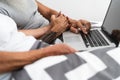 Senior couple using portable computer in bed - Mature people having fun with laptop while lying below blankets in bedroom Royalty Free Stock Photo