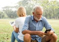 Senior couple using smartphone, People hands addicted by mobile smart phone - Technology concept with connected men and women Royalty Free Stock Photo