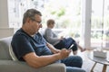 Senior couple using their mobile phones at home Royalty Free Stock Photo