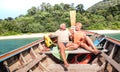 Senior couple vacationer relaxing at island hopping tour after beach exploration during snorkel boat trip in Thailand - Active Royalty Free Stock Photo