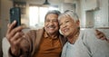 Senior couple, video call and wave on sofa, smile and hug with love, phone and relax in retirement in home. Elderly Royalty Free Stock Photo