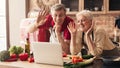 Senior couple video calling on laptop waving at screen Royalty Free Stock Photo