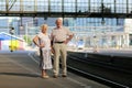 Senior couple waiting for train at railway station Royalty Free Stock Photo