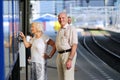 Senior couple waiting for train at railway station Royalty Free Stock Photo