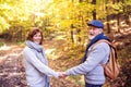 Senior couple on a walk in autumn forest. Royalty Free Stock Photo