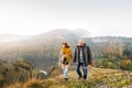 Senior couple on a walk in an autumn nature. Royalty Free Stock Photo