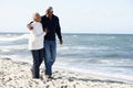 Senior Couple Walking Along Beach Together Royalty Free Stock Photo