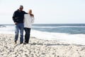 Senior Couple Walking Along Beach Together Royalty Free Stock Photo